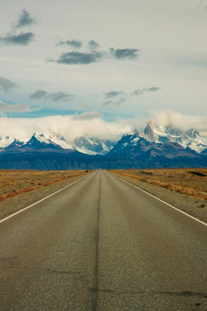 Explore the breathtaking view of Mount Fitz Roy from a deserted road in El Chaltén, Argentina.